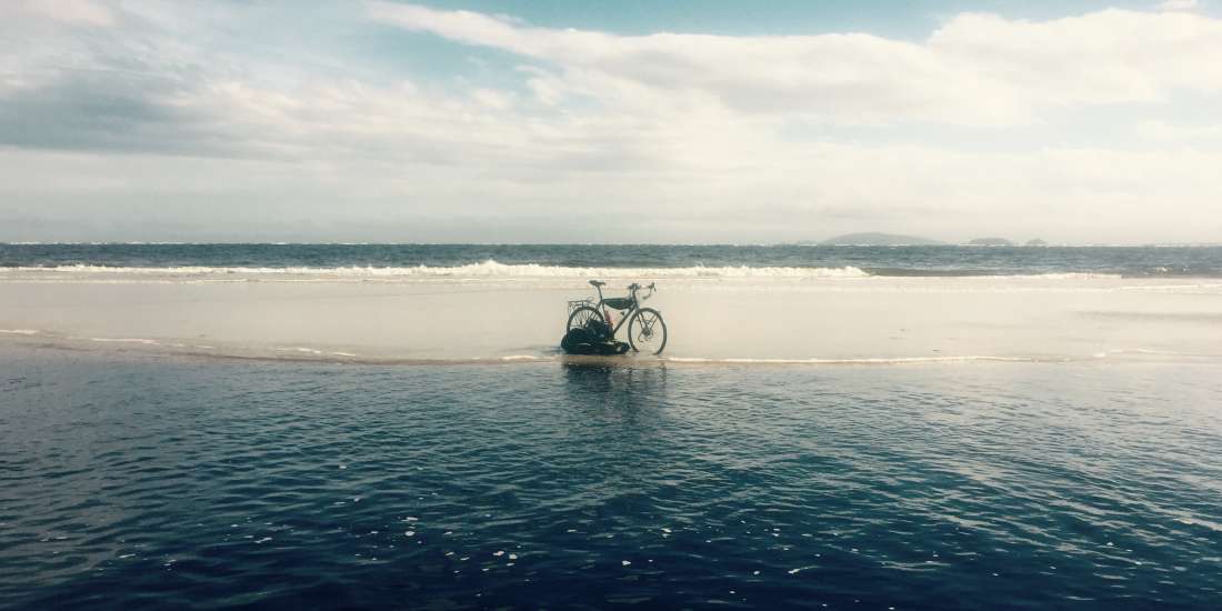 Lagoon and bike on beach near Superagui, Brazil