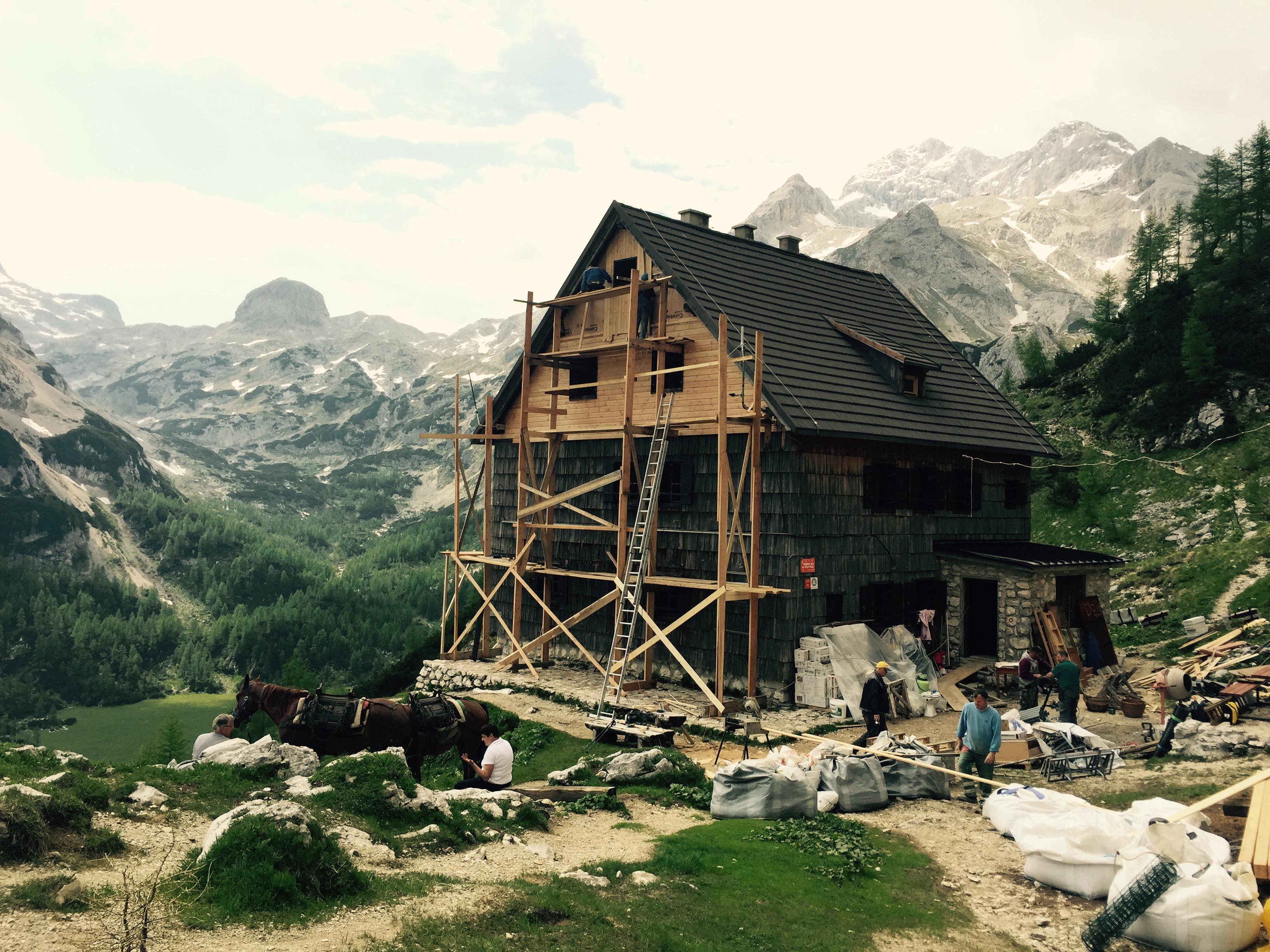 Vodnikov Dom clad with scafolding, Mt Triglav behind