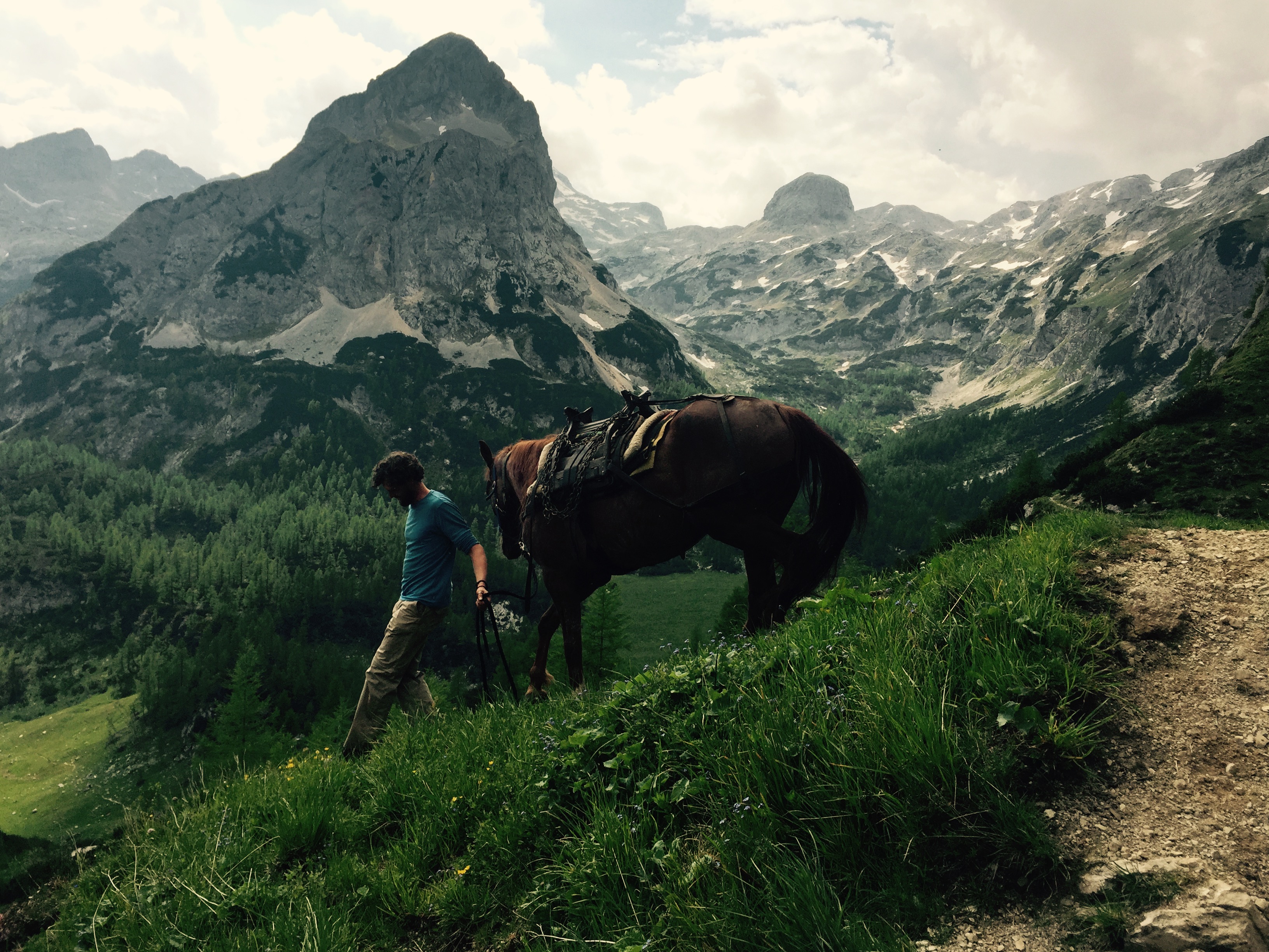 Leading pack horse down from Vodnikov Dom