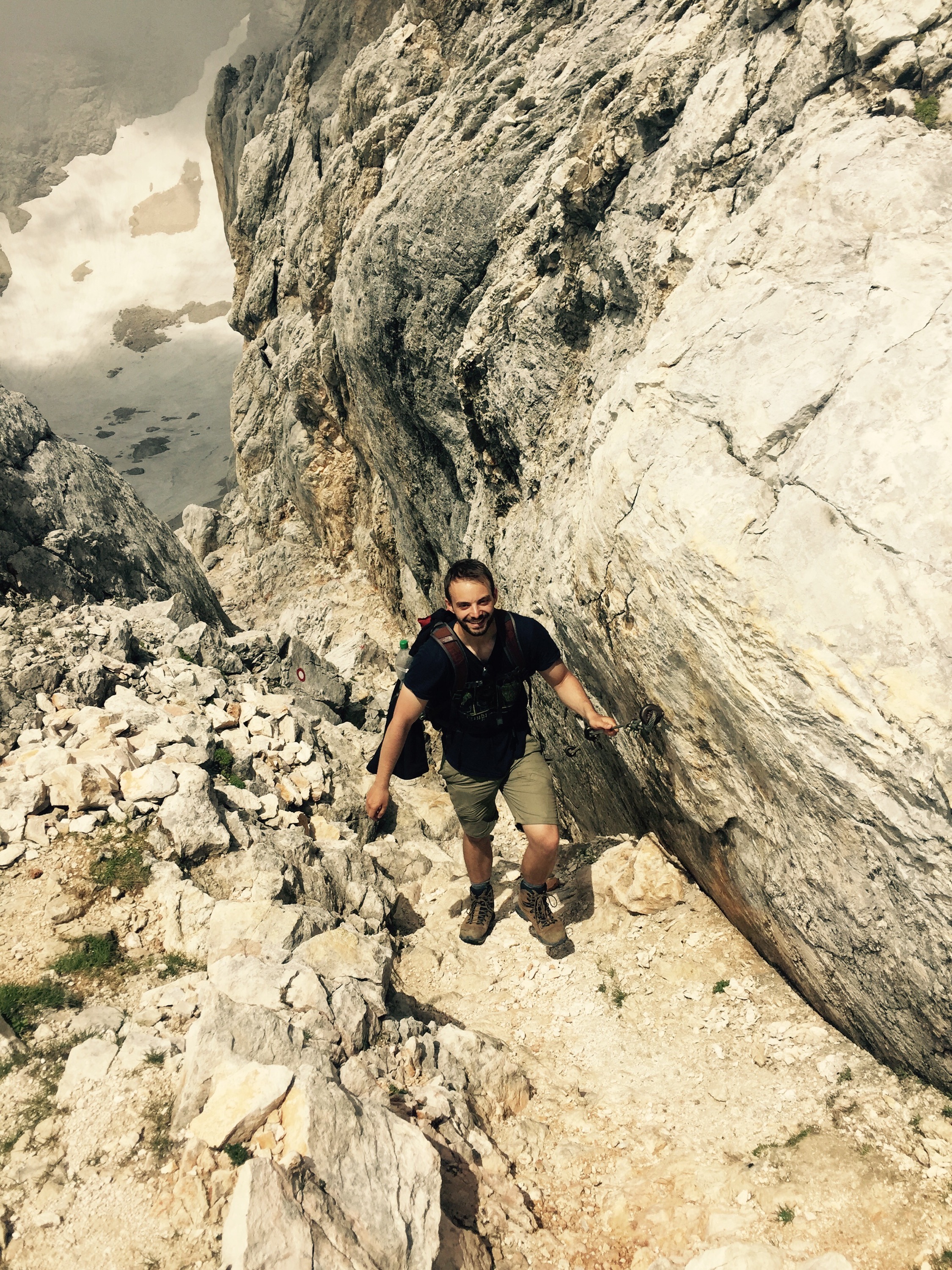 Nils on the steep loose south approach to Tiglave