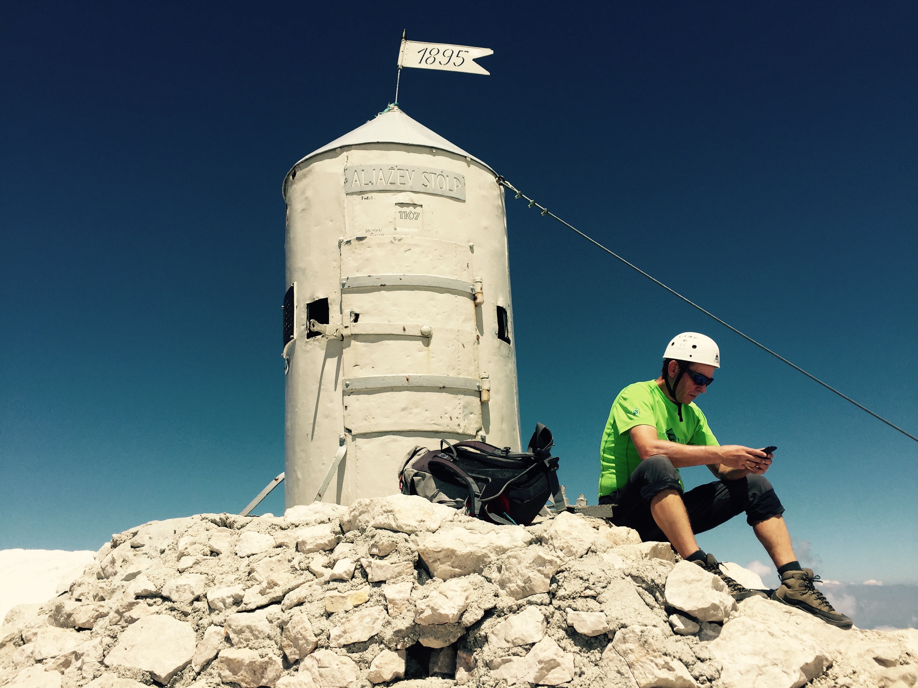 Summit of Triglav with modern mountaineer