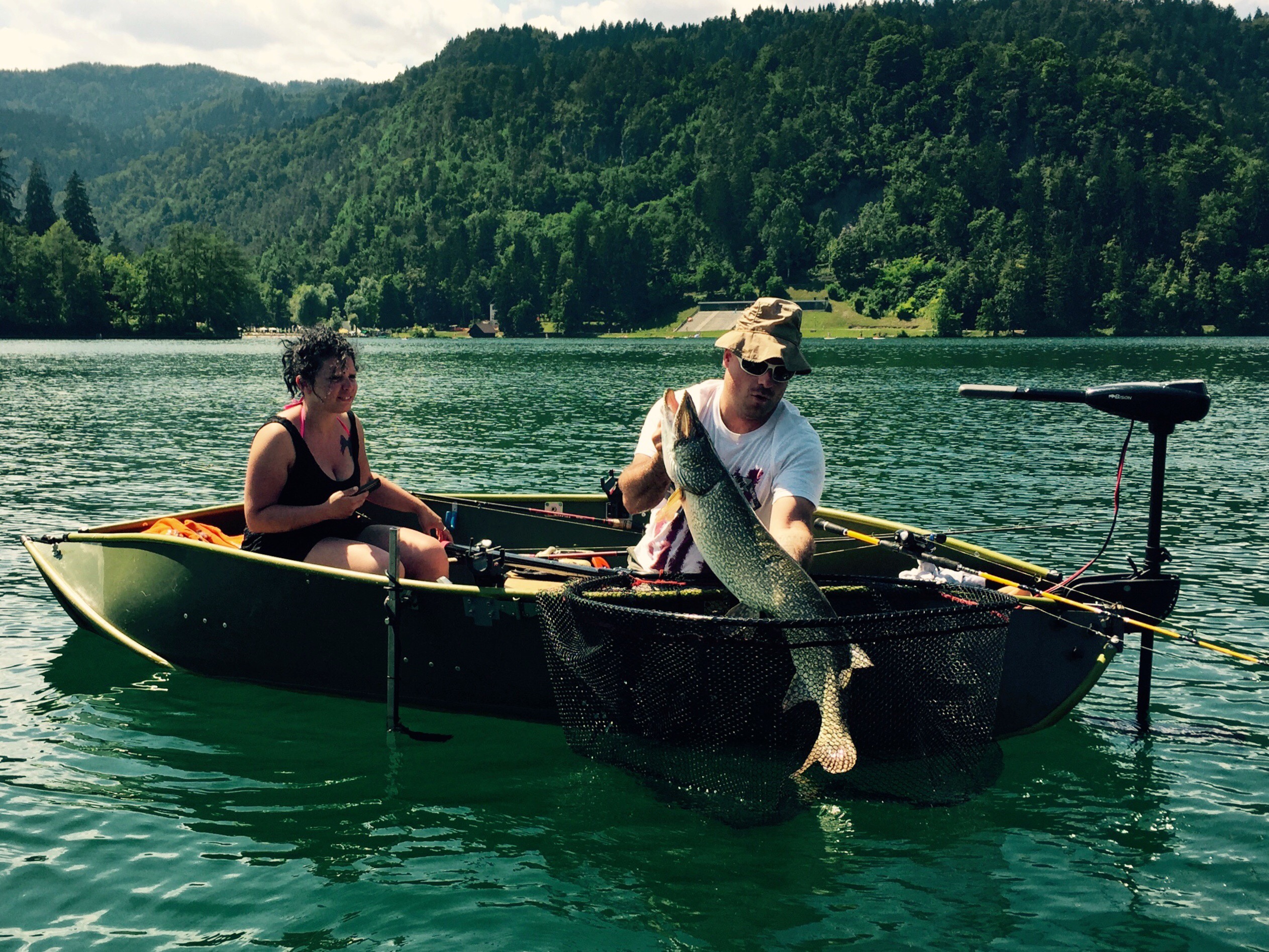 Fisherman and massive pike, lake Bled, Slovenia