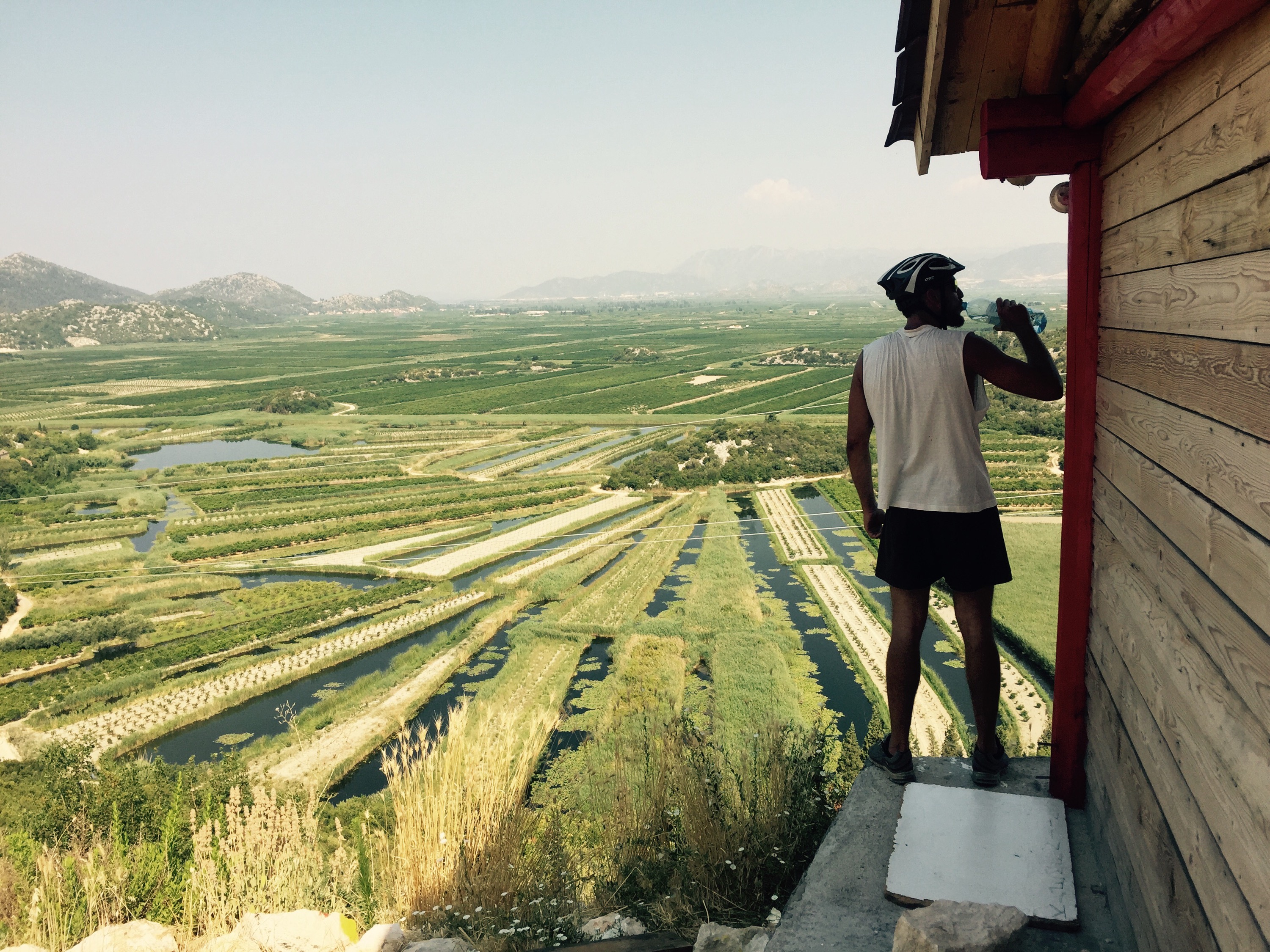 Ervin drinking over the Croatian farm lands