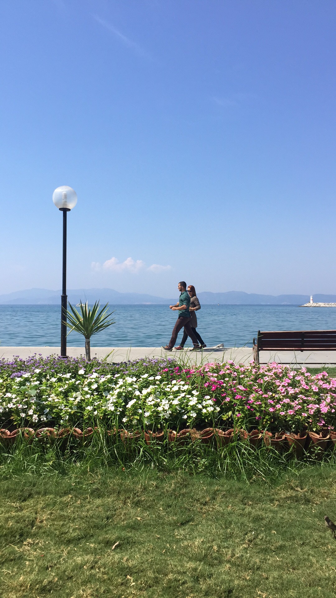 Couple walking along seafront, Turkey