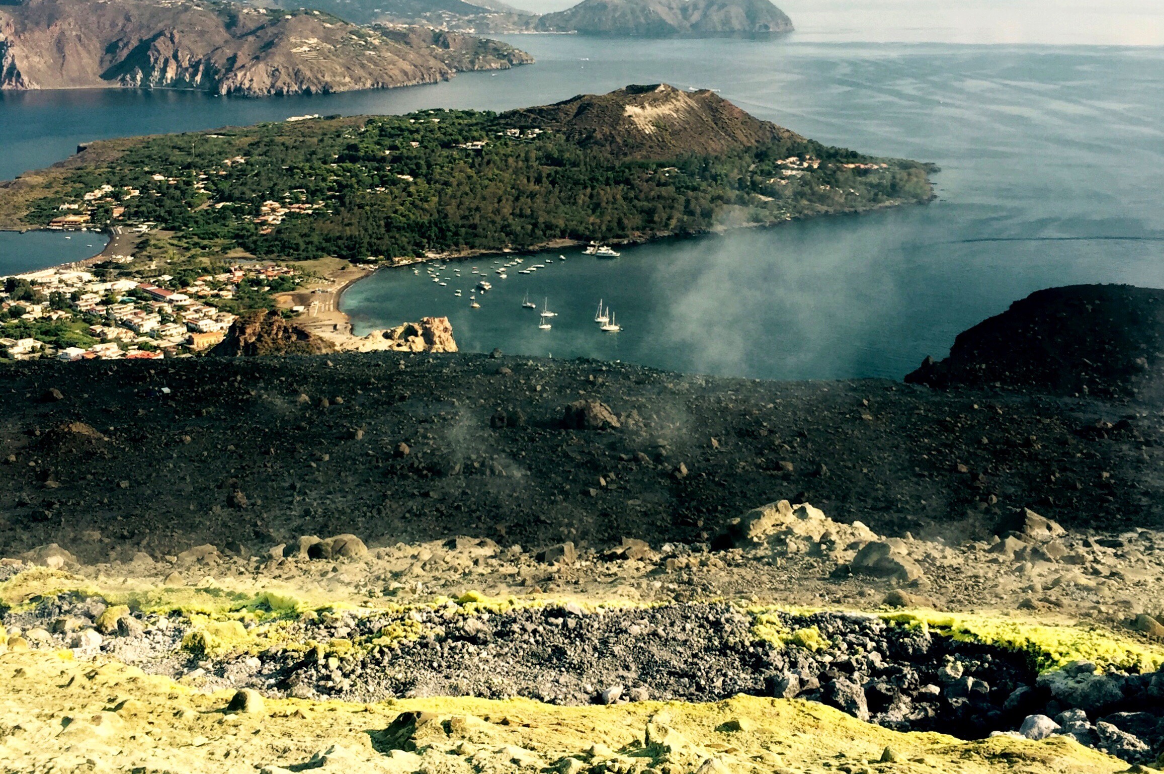 Sulpher vents and boats in the harbour, Vulcano, Sicily