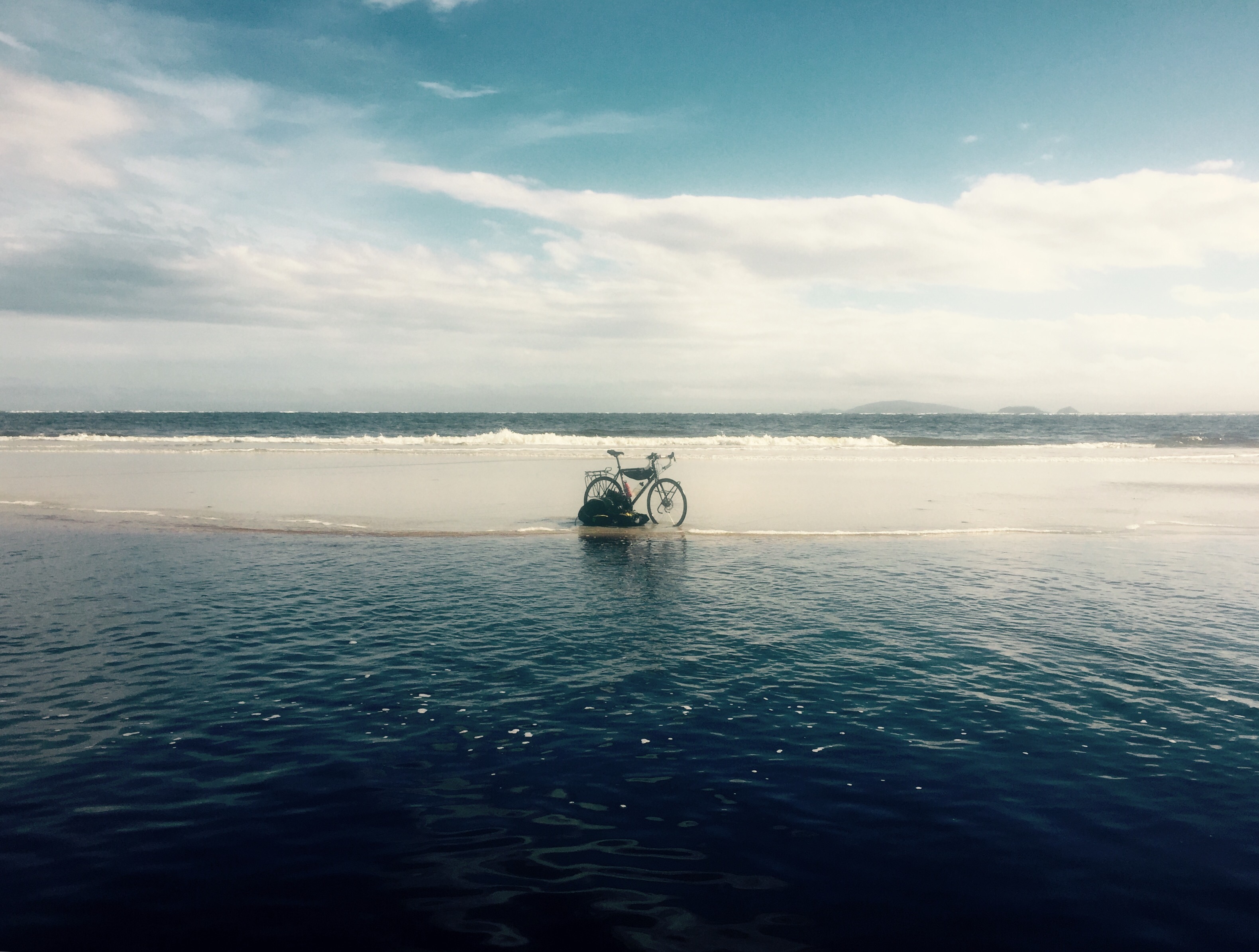 Lagoon and bike on beach near Superagui, Brazil